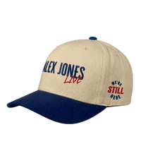 The Alex Jones Store - Side view of tan and navy Alex Jones Live Tan Embroidered Hat with 'ALEX JONES Live' front logo and 'We're Still Here' side stamp
