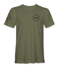 The Alex Jones Store - Front of olive green 1776 America Supply Co t-shirt with small left-chest Betsy Ross ring and 1776 numerals