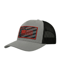 The Alex Jones Store - Angled side view of grey America Supply Co trucker hat with red-bordered American flag patch and black mesh back