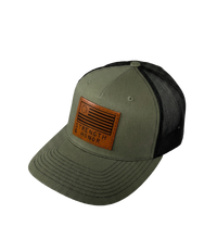The Alex Jones Store - Angled view of olive green Strength & Honor leather patch trucker hat with black mesh side panels and curved brim