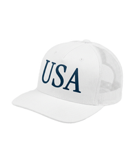 The Alex Jones Store - White 'USA' Premium Trucker Hat with navy serif USA logo, side-angle view showing mesh back and curved bill