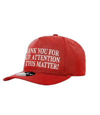 The Alex Jones Store - Red 'Thank You For Your Attention To This Matter!' trucker hat three-quarter view with white embroidered front text