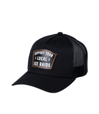 The Alex Jones Store - Black trucker hat three-quarter view with 'Support Your Local ICE Raids' leather patch on front and mesh back