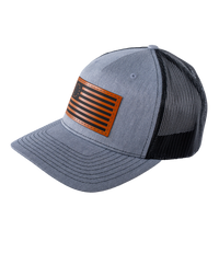 The Alex Jones Store - Three-quarter view of heather grey Betsy Ross American Flag leather patch trucker hat with black mesh back panel