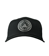 The Alex Jones Store - Front of black trucker hat with circular leather patch reading 'Rebellion To Tyrants Is Obedience To God' with Gadsden snake