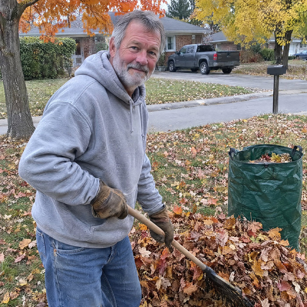 Man in his sixties raking leaves on a fall morning